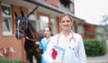 Veterinarian doctor holds horse certificate in background Royalty Free Stock Photo
