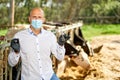 Veterinarian at farm cattle takes analyzes Royalty Free Stock Photo