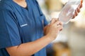 A veterinarian is preparing a saline syringe to clean the wound of a dog receiving treatment in clinic