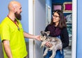 Veterinarian receiving a client with her pet