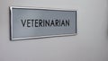 Veterinarian room door, visit to animal doctor for checkup, pets healthcare