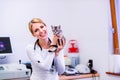 Veterinarian with stethoscope holding little sick cat.