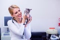 Veterinarian with stethoscope holding little sore cat. Veterinar Royalty Free Stock Photo