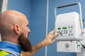 Veterinarian using an x-ray device with lead clothing