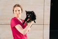 Veterinarian is a young girl in a medical gown holding a black cat in her arms Royalty Free Stock Photo