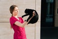 Veterinarian is a young girl in a medical gown holding a black cat in her arms Royalty Free Stock Photo