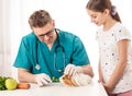 Veterinary showing guinea pig diet to girl Royalty Free Stock Photo