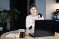 Veterinary Telemedicine Services, Online veterinarian services for virtual pet care. Young woman with cat and using Royalty Free Stock Photo