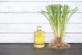 Vetiver grass or chrysopogon zizanioides and oil on an old wooden background