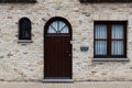 Veurne, West Flanders Region - Belgium - Rectangular facade in nature stone with a classic door and windows
