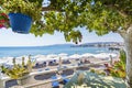 Vew of Haraki beach from table under tree Rhodes, Greece