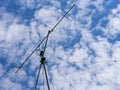 VHF radio antenna with stay ropes against cloudy sky Royalty Free Stock Photo