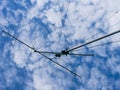 VHF radio antenna with a stay ropes against cloudy sky Royalty Free Stock Photo