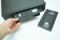 VHS videocassette is put into the video recorder to watch the video, another video cassette Royalty Free Stock Photo
