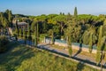 Via Appia Antica ancient stone road in Rome among green meadows and trees, Italy. Aerial view of European nature Royalty Free Stock Photo