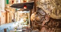 Via dei Tribunali street and sculpture of Pulcinella in Naples old town, Italy