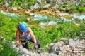 Via ferrata in Croatia, Cikola Canyon. Young woman climbing a medium difficulty klettersteig, with Cikola river turquoise colors. Royalty Free Stock Photo