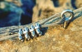 Via ferrata steel rope on a rock detail. Steel chrome anchor