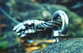 Via ferrata steel rope on a rock detail. Steel chrome anchor