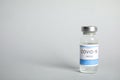 Vial with coronavirus vaccine on light background, space for text Royalty Free Stock Photo