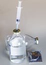 A vial of medicine with a syringe