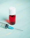 Vial with red liquid and syringe Royalty Free Stock Photo