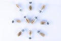 Vials, ampoules with a dry probiotic, bifidobacteria inside on a white background are laid out in the form of a clock. Copy space