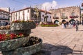 Viana do Castelo PORTUGAL - August 5, 2021 - Selective focus on flower pots in the PraÃÂ§a da RÃÂ©publica with fountain and monument Royalty Free Stock Photo