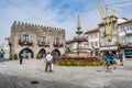 Viana do Castelo PORTUGAL - August 5, 2021 - Tourists strolling in the Republica square next to the fountain and with the old town Royalty Free Stock Photo