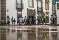 VIANA DO CASTELO, PORTUGAL - JULY 30, 2021: Organised group of children walking down the street with seniors in green vests Royalty Free Stock Photo