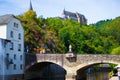 Vianden Castle on a hill with a bridge, a restaurant and Our river in Vianden, Luxembourg Royalty Free Stock Photo