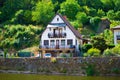 Vianden, Luxembourg; 08/12/2018: Typical house of Vianden in Luxembourg, with Our river in the foreground and a forest in the Royalty Free Stock Photo