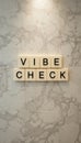 Vibe Check Wall Art with Letters on a Marble Background Royalty Free Stock Photo