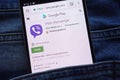 Viber Messenger app on Google Play website displayed on smartphone hidden in jeans pocket