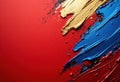 Vibrant abstract paint strokes in red, blue, and gold on a textured background Royalty Free Stock Photo