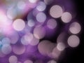 Vibrant purple and white glowing blurred lights on a black abstract background Royalty Free Stock Photo
