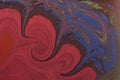 Vibrant abstract texture in ebru technique with swirling repetitive elements in red color