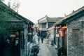 Vibrant alleyway featuring traditional stone buildings and ornate lanterns in Huaian, China