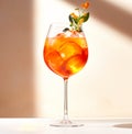 A vibrant Aperol Spritz cocktail garnished with orange slice and ice cubes