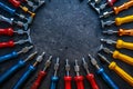 Colorful dent repair tools arranged in a circle on a dark textured surface Royalty Free Stock Photo