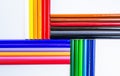 A Vibrant Array of Colored Pencils on a Clean White Surface. A group of different colored pencils on a white surface