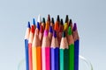 A Vibrant Array of Colored Pencils in a Glass Cup. A group of colored pencils sitting in a glass cup