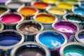 Vibrant array of open paint cans displaying a spectrum of colors for creative projects and home renovation Royalty Free Stock Photo