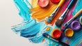 Vibrant art supplies with paint brushes and colorful strokes. Top view. Art palette with oil paints and brushes. theme with paint