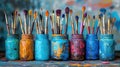 Vibrant Art Workshop Scene with Colorful Paintbrush Jars on a Messy Table, Capturing the Creative Process Royalty Free Stock Photo