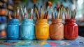 Vibrant Art Workshop Scene with Colorful Paintbrush Jars on a Messy Table, Capturing the Creative Process Royalty Free Stock Photo