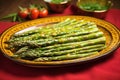 vibrant asparagus with bronze tops on a vibrant, ceramic platter