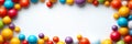 Vibrant Assorted Gumballs Forming A Cheerful Border On A Soft White Background With Copyspace Royalty Free Stock Photo