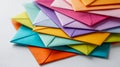 A vibrant assortment of colorful envelopes neatly stacked on a white surface symbolizing communication and celebration in a Royalty Free Stock Photo