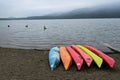 Vibrant assortment of kayaks resting on the sandy shore